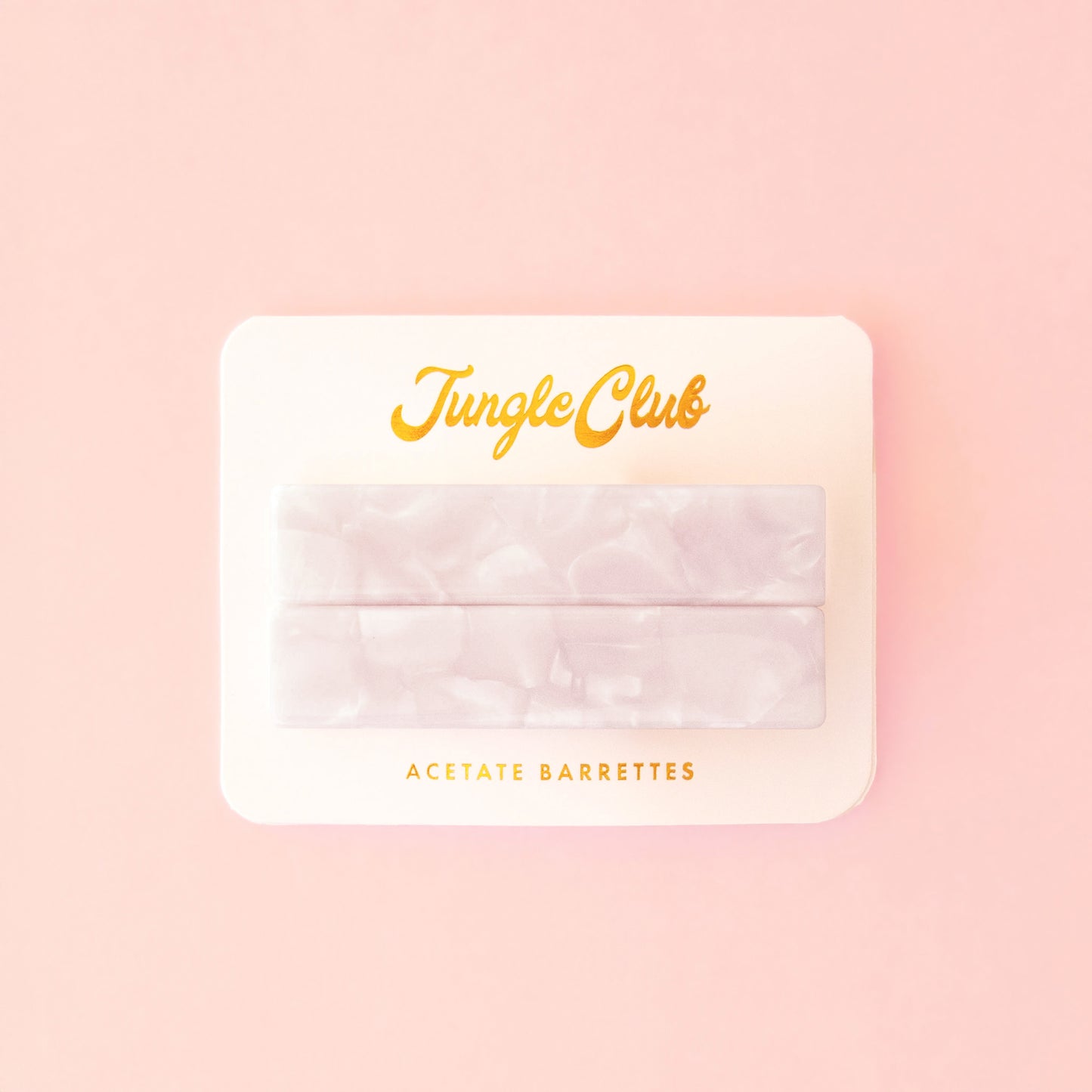 Marbled white acetate barrettes on a pink ground card that reads, "Jungle Club".