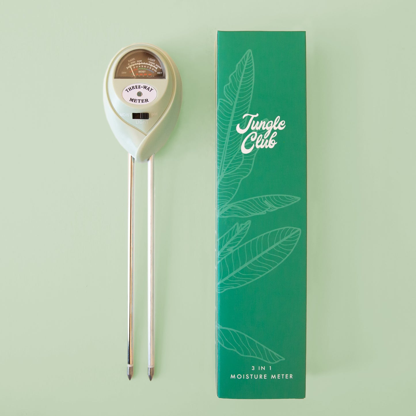 A moisture meter with a green box packaging next to it.