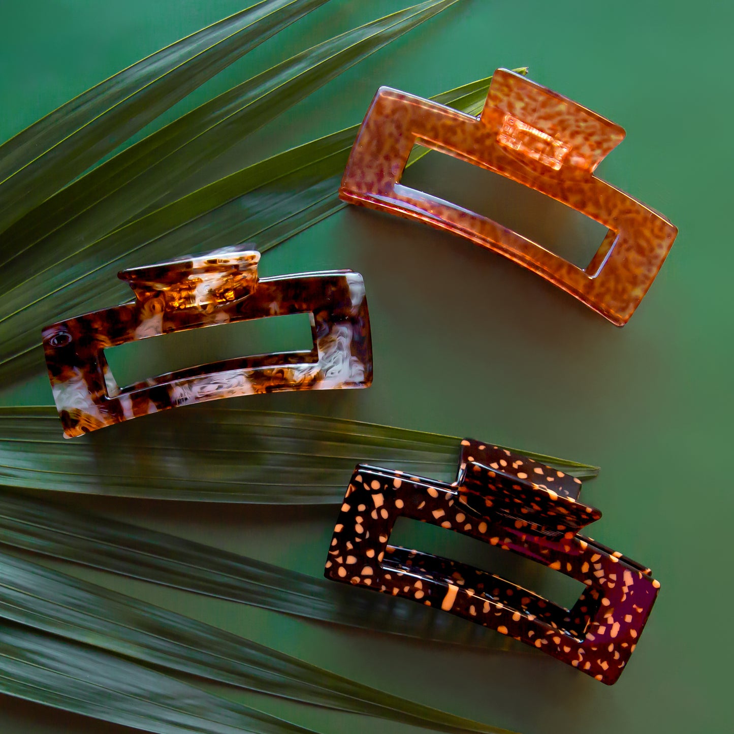 A trio of hair clips in different animal print patterns.