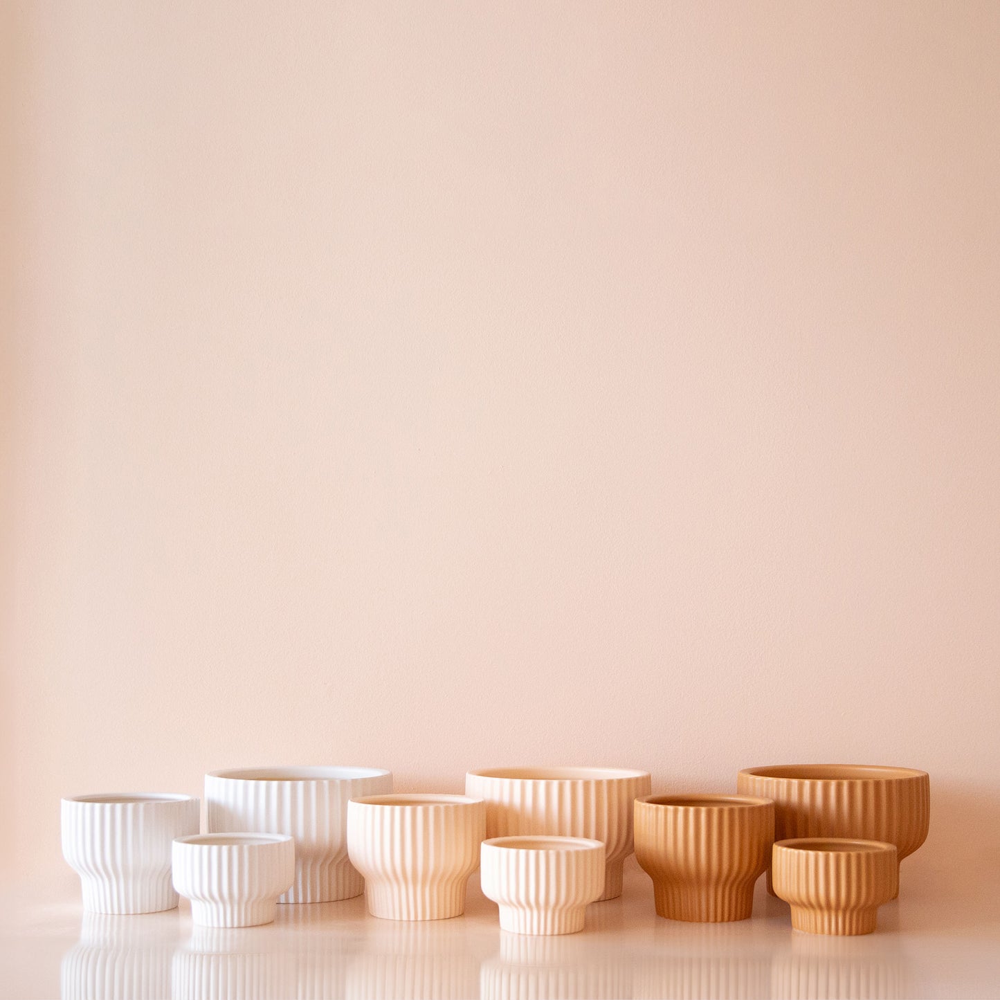 All three color ways of the Presley Planter. From left to right, the photo has White, Ballerina and then Ginger.
