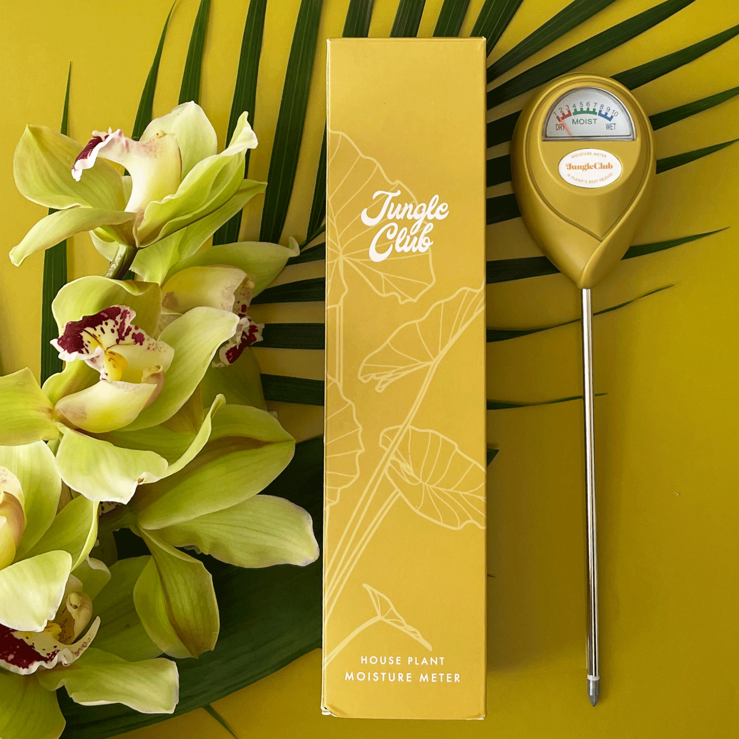 A chartreuse moisture meter with a rounded head and a white meter that ranges from dry, moist, or wet along with a small oval label in the front that reads, "Jungle Club".