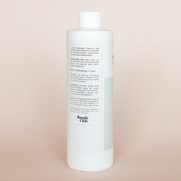 White bottle of House Plant fertilizer with a light blue label.