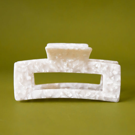 A pearly white rectangle claw clip. 