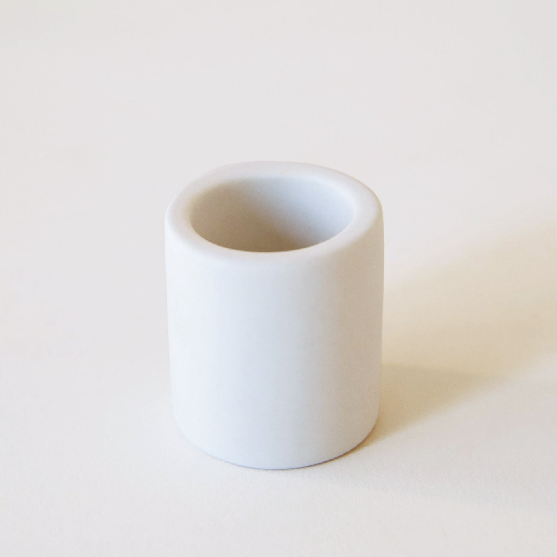 This white ceramic tiny pot is only an inch high, and has a smooth ceramic matte finish.